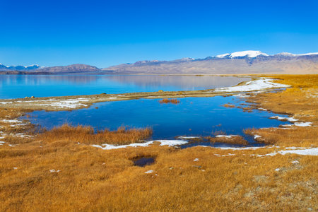 Beauty Karakul lake. Karakul or Qarokul lake is located in the Pamir Mountains near the border with China and Kyrgyzstan in Murghab region in Tajikistan.の写真素材