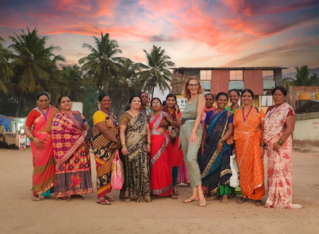 Goa, India - January 28, 2023: Causacian woman posing together with indian women in traditional sari dress in Goa, Indiaのeditorial素材