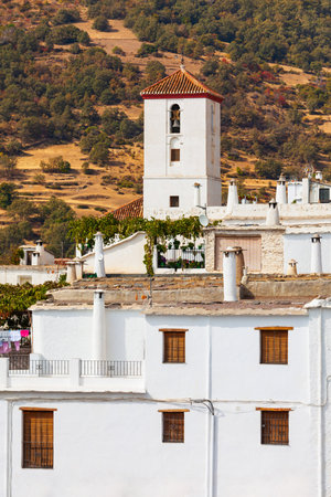 Church of Santa Maria Maggiore in Capileira village. Capileira is the highest village in the Alpujarras area in the province of Granada in Andalusia, Spain.の写真素材