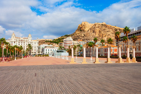 Port square and Santa Barbara Castle on background. Santa Barbara Castle is a fort stands on Mount Benacantil in the center of Alicante, Spain.の写真素材