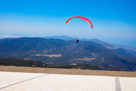 Flying paraglider at the top of Babadag mountain in Turkey. Oludeniz or Blue Lagoon is a beach resort in the Fethiye district of Mugla Province, Turkey.の写真素材