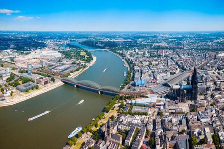 Cologne Cathedral and Hohenzollern Bridge through Rhine river in Cologne, Germanyの写真素材