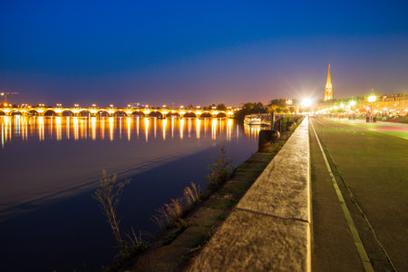 Pont de Pierre bridge in Bordeaux at night. Bordeaux is a port city on the Garonne river in Southwestern Franceの写真素材