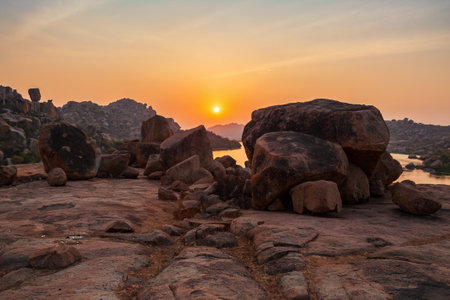 Mountain with boulders and river at Hampi, the centre of the Hindu Vijayanagara Empire in Karnataka state in Indiaの写真素材