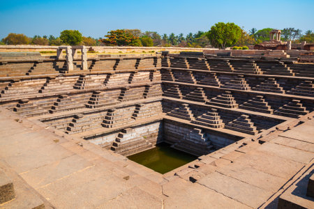 A stepped square water tank at Hampi, the centre of the Hindu Vijayanagara Empire in Karnataka state in Indiaの写真素材