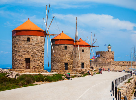 Windmills at the seafront in the city of Rhodes in Rhodes island in Greeceの写真素材