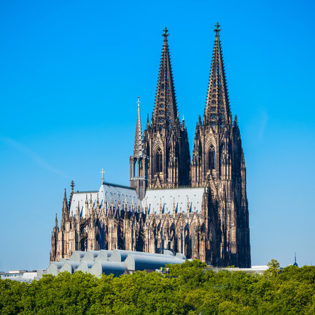 Cologne Cathedral and Hohenzollern Bridge through Rhine river in Cologne, Germanyの写真素材