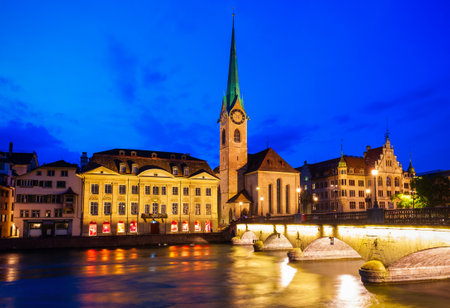 Fraumunster Church and Munsterbrucke bridge through Limmat river in the centre of Zurich city in Switzerlandの写真素材