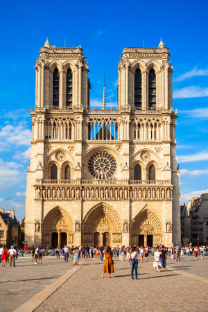 Notre Dame de Paris or Notre-Dame Cathedral is a medieval Catholic cathedral in Paris, France. Some people are with blurred faces.の写真素材
