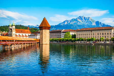 Kapellbrucke or Chapel Bridge is a wooden footbridge spanning Reuss river and Wasserturm water tower in Lucerne city, central Switzerlandの写真素材
