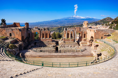 The Ancient Theatre of Taormina or Teatro antico di Taormina and Etna volcano aerial view, it is an ancient Greek theatre in Taormina city, Sicily island, Italyの写真素材