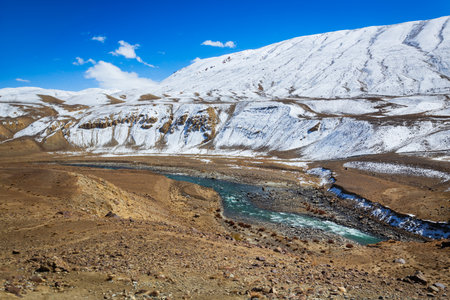 The Wakhan Corridor river and mountain landscape view from the Pamir highway. Wakhan Corridor is located on the border between Tajikistan and Afghanistan.の写真素材