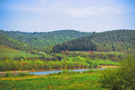 View of the Carpathians, river, hills and houses awayの写真素材