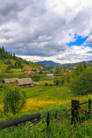 Small Carpathian settlement is located between the blue mountains. Ukraine. Slavske.の写真素材