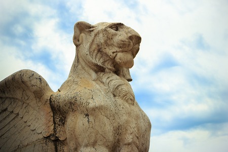 Lion with wings against the sky with clouds. Architecture.の写真素材