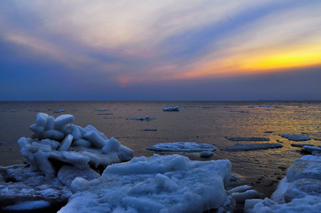 Winter seascape with ice floes been washed ashoreの写真素材