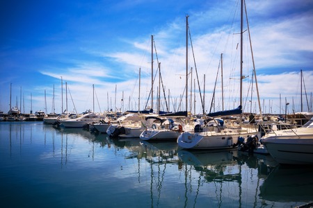 Photo of incredible beauty Harbor Yacht Club with glazed clear sea and blue clouds. Italy. Nettuno.の写真素材