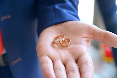 Gold Wedding Rings on a Male Handの写真素材