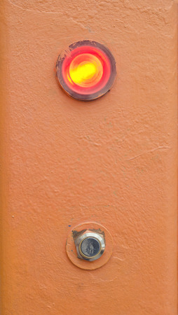 button and red indicator on orange backgroundの写真素材
