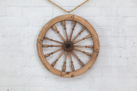 Steering wheel on a white brick wall backgroundの写真素材