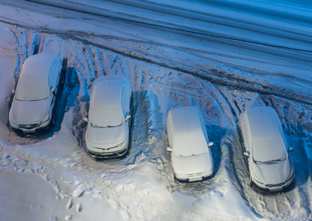 cars in the snow on parkingの写真素材