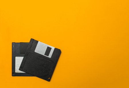two diskette on yellow background