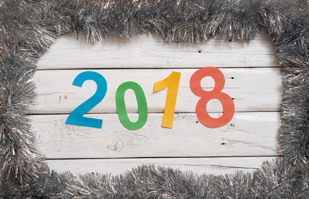 2018 new year on white wood on tinsel