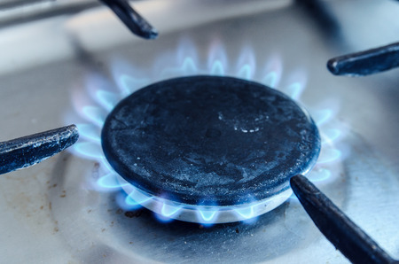 old gas stove with burning gas