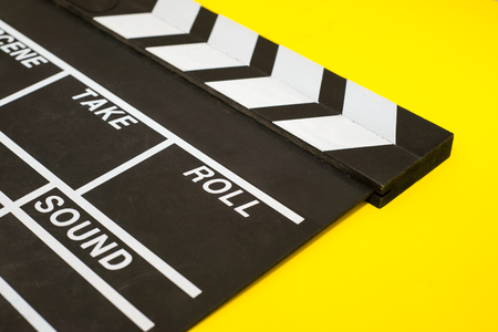 Movie clapper on a yellow backgroundの写真素材