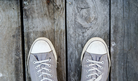 Lined sneakers on a wooden backgroundの写真素材