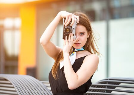 Young and beautiful girl with vintage cameraの写真素材
