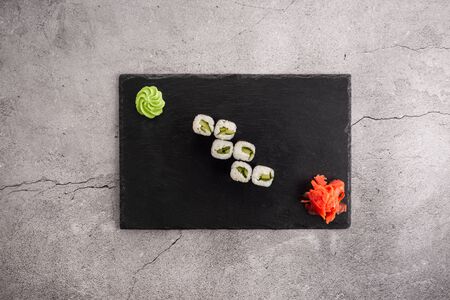Japanese rolls with cucumber on a slate boardの写真素材