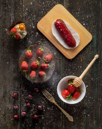 Styling strawberrie and cherry on wood background