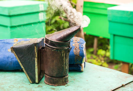 Beekeeping tools smoker on the background of hivesの写真素材