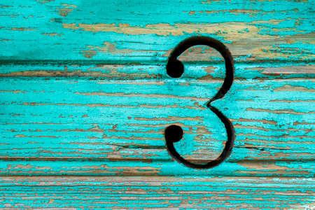 The number 3 on the green rustic boardsの写真素材