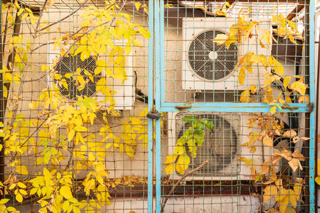 Air conditioners on the background of the wall, outside. Autumn