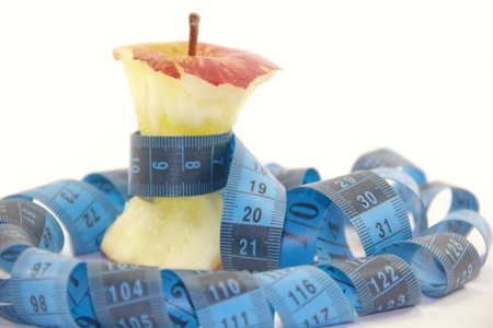 Apple core with a blue tape measure