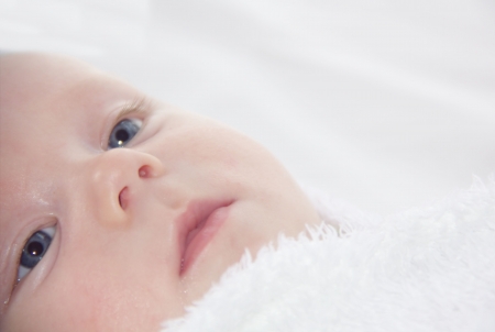 Close up baby face looking upの写真素材