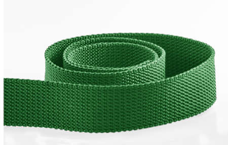 a green rough textured nylon cloth belt isolated on a white backgroundの写真素材