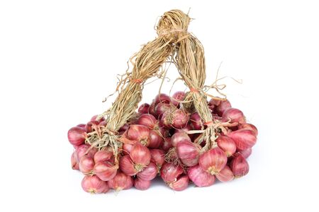 Like garlic, shallots are formed in clusters of offsets with a head composed of multiple cloves. Their skin color can vary from golden brown   to gray to rose red, and their off-white flesh is usually tinged with green or magenta. Shallots are popular witの写真素材