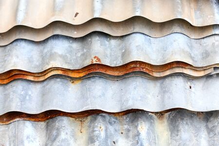 Stack sheet zinc corrode are dangerous if not careful in usage. Galvanized steel sheet piles are dangerous if not carefully used. The galvanized sheet rust dangerous if the careless use.の写真素材