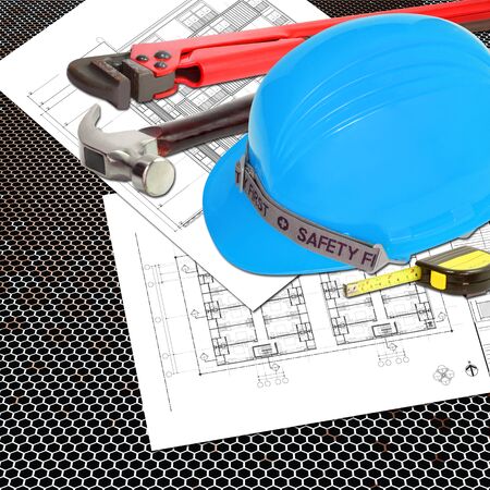 Blue Helmet of foreman or guest constructor with blueprints building construction and tools, metal tape measure, hammer, wrenchの写真素材