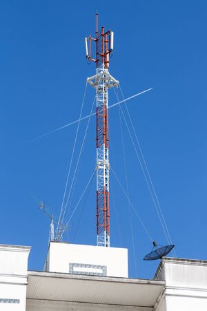 A cell site, cell tower, or cellular base station is a cellular-enabled mobile device site where antennae and electronic communications equipment are placed to create a cell in a cellular networkの写真素材