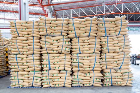 stacked sacks in store. A warehouse is a commercial building for storage. Warehouses are used by manufacturers, importers, exporters, wholesalers, 
transport businesses before distribution to the buyerの写真素材