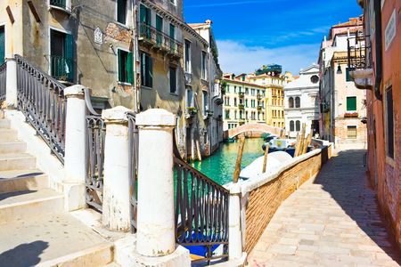 Small bridge over greenish water of a venetian canal, Italyの写真素材