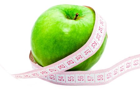 Measuring a green appleの写真素材