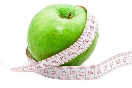 Measuring a green appleの写真素材