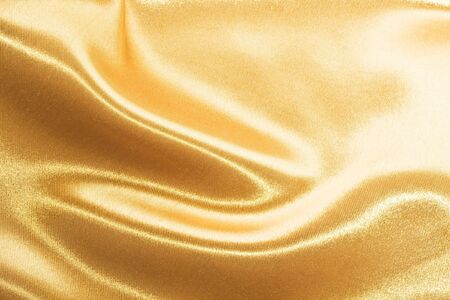 Golden satin or silk backgroundの写真素材