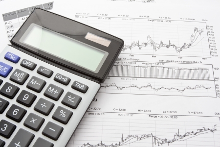 Close-up photo of business objects: calculator and diagramsの写真素材