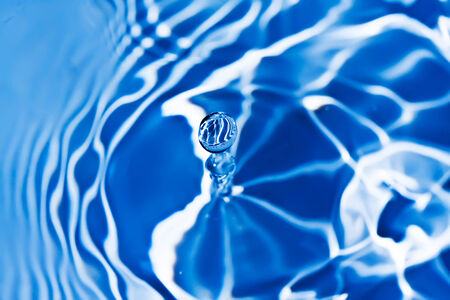 Blue transparent water splashes on white backgroundの写真素材